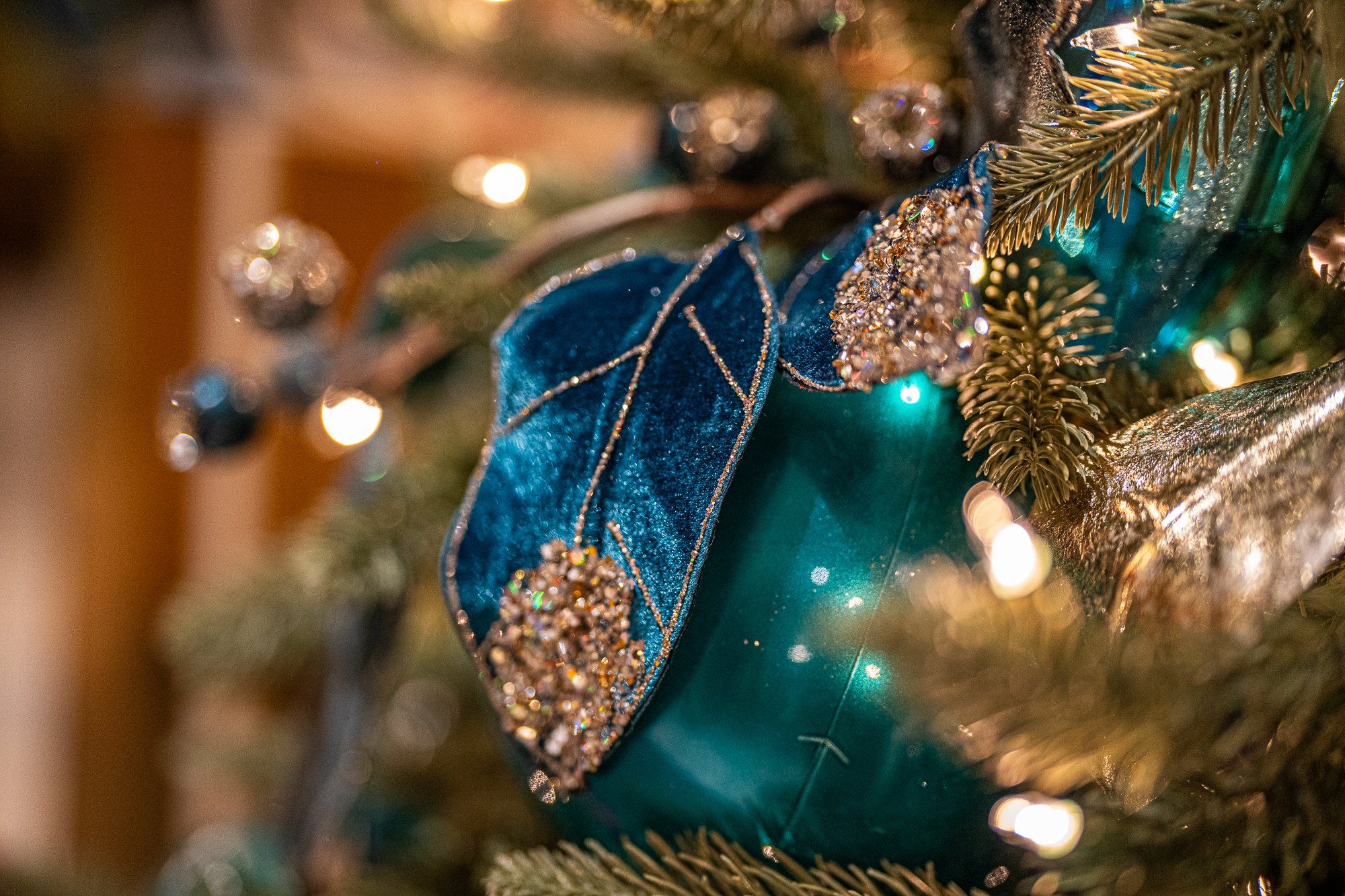 Navy velvet leaves and gold accents with jewel ornaments on the tree